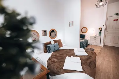 a bedroom with a bed and a christmas tree at Casa Branca Apartments by TrIp2Portugal in Funchal