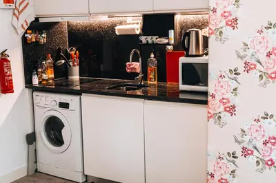 a kitchen with a washing machine and a sink at Casa Branca Apartments by TrIp2Portugal in Funchal