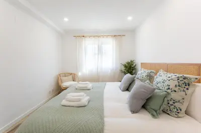 a bedroom with a large bed with pillows at Nōhō house in Carrapateira