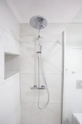 a shower with a shower head in a bathroom at Nōhō house in Carrapateira