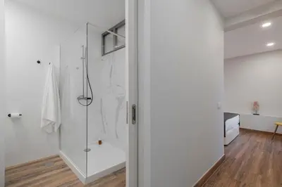 a bathroom with a shower with a glass door at Alegria Flat by An Island Apart in Funchal