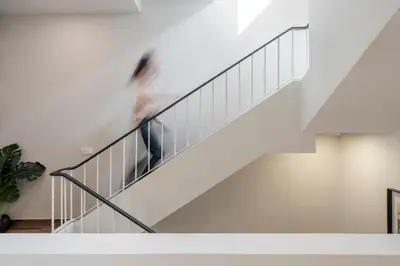 a person walking down the stairs of a house at Alegria Flat by An Island Apart in Funchal