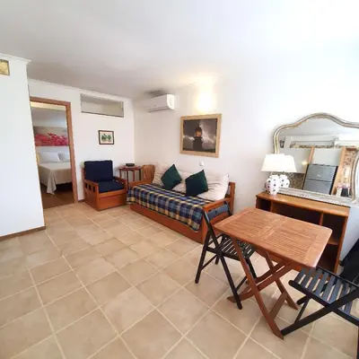 a living room with a couch and a table at Cosy Apartment in Sagres, 42 sqm with Garden View in Sagres