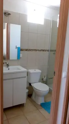 a bathroom with a toilet and a sink and a shower at Cosy Apartment in Sagres, 42 sqm with Garden View in Sagres