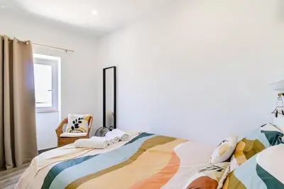 a bedroom with a bed and a chair at Casa Sabino in Almádena