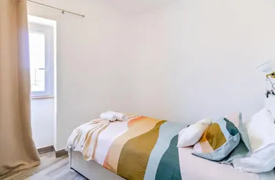 a bedroom with a bed with a colorful blanket at Casa Sabino in Almádena