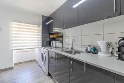a kitchen with a sink and a dishwasher at Casa Sabino in Almádena