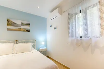 a bedroom with a bed with a flower on it at Bela casa na Costa Vicentina in Aljezur
