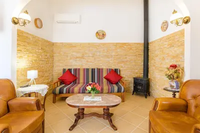 a living room with two couches and a fireplace at Bela casa na Costa Vicentina in Aljezur