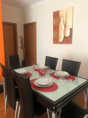a dining room table with chairs and wine glasses at Ocean Garden in Caniço
