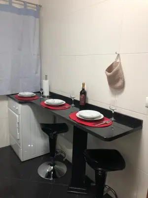 a black table with plates and wine glasses on it at Ocean Garden in Caniço