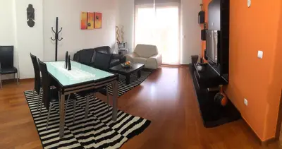 a living room with a table and a couch at Ocean Garden in Caniço