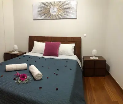 a bedroom with a bed with flowers on it at Ocean Garden in Caniço
