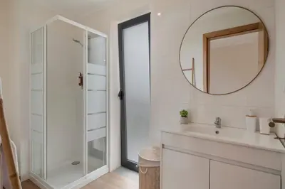 a bathroom with a shower and a sink and a mirror at Casinha dos Canhas by An Island Apart in Ponta do Sol
