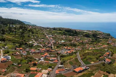 an aerial view of a small town on a hill next to the ocean at Casinha dos Canhas by An Island Apart in Ponta do Sol