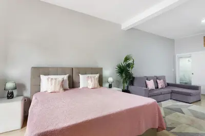 a bedroom with a large bed and a couch at Studio Home Away from Home in Caniçal