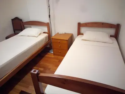 a bedroom with two beds and a night stand at Costa Lodges Funchal, Santa Cruz, private room in Santa Cruz