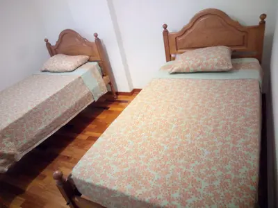 two beds sitting next to each other in a room at Costa Lodges Funchal, Santa Cruz, private room in Santa Cruz