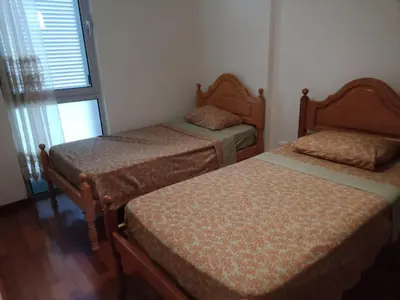 a bedroom with two beds and a window at Costa Lodges Funchal, Santa Cruz, private room in Santa Cruz