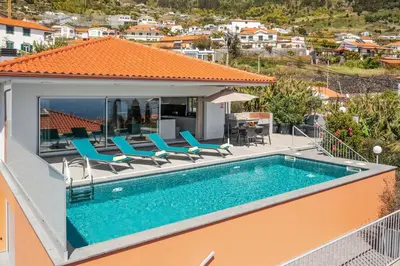 a swimming pool on the roof of a house at OurMadeira - Arco Sun in Arco da Calheta