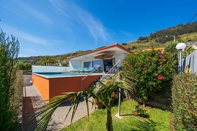a house with a swimming pool and a garden at OurMadeira - Arco Sun in Arco da Calheta