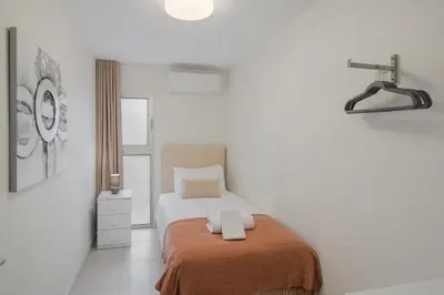 a bedroom with a bed with two towels on it at OurMadeira - Arco Sun in Arco da Calheta