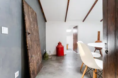 a room with a table and chairs and a red fire hydrant at Casa Alfambras - Holiday Cottage in Aljezur by Lisbeyond in Aljezur