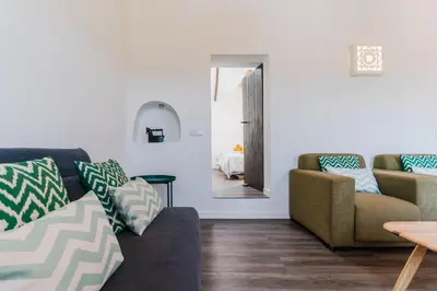 a living room with a couch and a table at Casa Alfambras - Holiday Cottage in Aljezur by Lisbeyond in Aljezur