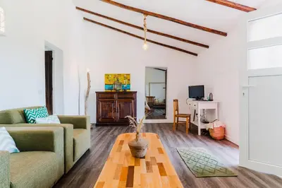 a living room with a couch and a table at Casa Alfambras - Holiday Cottage in Aljezur by Lisbeyond in Aljezur