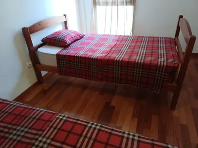 a bedroom with a bed with a red plaid blanket at Costa Lodges Funchal or Santa Cruz, Madeira in Santa Cruz