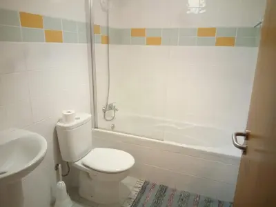a bathroom with a toilet and a sink and a tub at Costa Lodges Funchal or Santa Cruz, Madeira in Santa Cruz