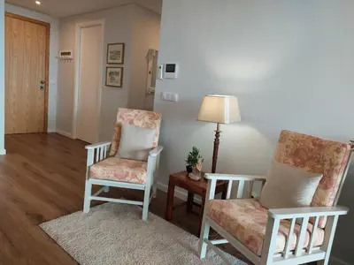 a living room with two chairs and a table at Stunning Lobos View in Câmara de Lobos