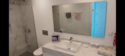 a bathroom with a sink and a shower and a mirror at Stunning Lobos View in Câmara de Lobos