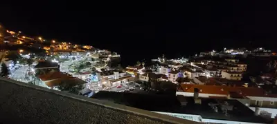 a view of a city at night with lights at Stunning Lobos View in Câmara de Lobos
