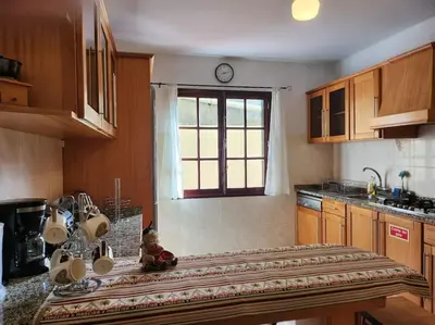 a kitchen with a table with a teddy bear on it at Gomes house in Ponta do Sol