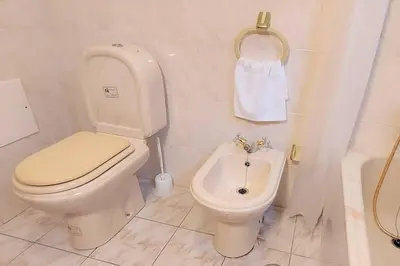 a bathroom with a toilet and a bidet and a sink at Gomes house in Ponta do Sol
