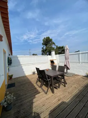 a patio with a table and chairs on a deck at Sunny Aljezur da Viana, (Aljezur, Costa Vicentina) in Aljezur