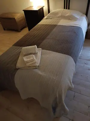 a bed with two towels on top of it at Sunny Aljezur da Viana, (Aljezur, Costa Vicentina) in Aljezur