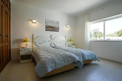 a bedroom with a bed and a large window at Ramalhete panoramic view apartment in Luz