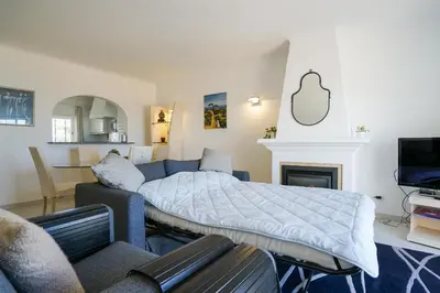 a living room with a bed and a couch at Ramalhete panoramic view apartment in Luz