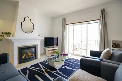 a living room with a couch and a fireplace at Ramalhete panoramic view apartment in Luz