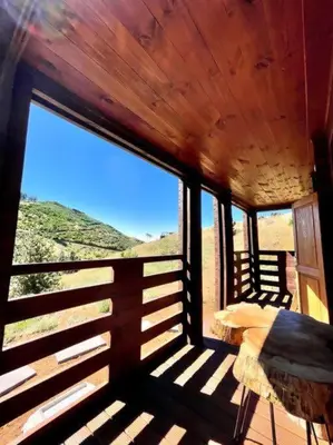 a bedroom with a large window in a cabin at Mountain Eco Shelter 9 in Funchal
