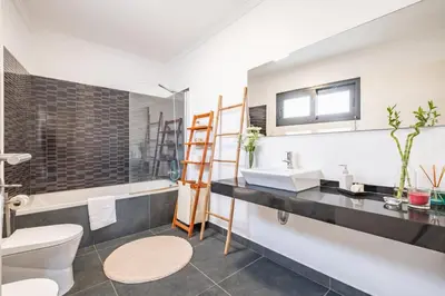 a bathroom with a sink and a toilet and a tub at Uptown Sea View by Homie in Funchal