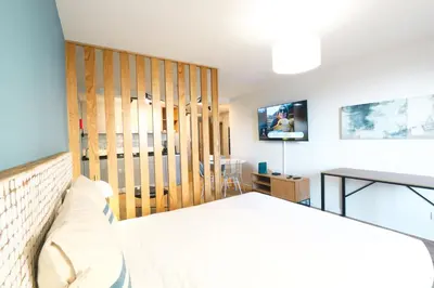 a bedroom with a bed and a tv on a wall at Marina Club Studio Traveller Hideaway in Funchal
