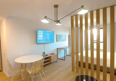 a room with a bed and a table and chairs at Marina Club Studio Traveller Hideaway in Funchal
