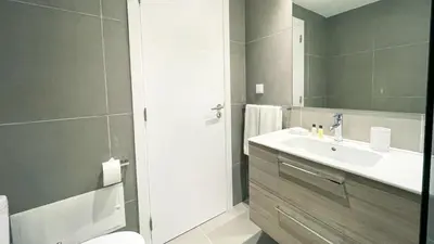 a bathroom with a white sink and a shower at Marina Club Studio Traveller Hideaway in Funchal