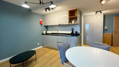 a kitchen with a table and chairs in a room at Marina Club Studio Traveller Hideaway in Funchal