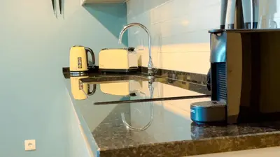 a bathroom counter with a sink with a faucet at Marina Club Studio Traveller Hideaway in Funchal