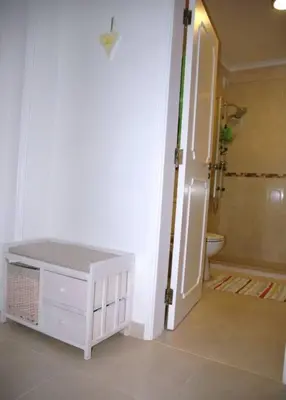 a bathroom with a shower and a toilet and a door at Lovely 1 Bedroom apartment in Praia da Luz in Luz