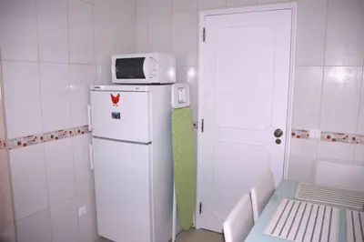 a kitchen with a microwave on top of a refrigerator at Lovely 1 Bedroom apartment in Praia da Luz in Luz